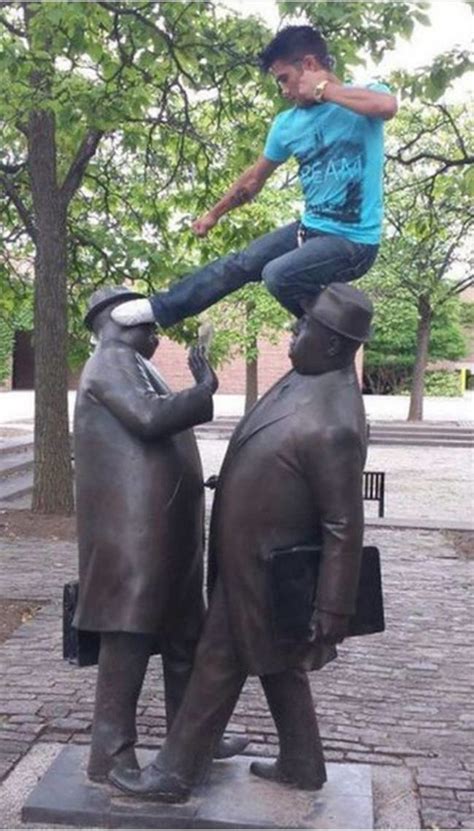 people messing around with statues